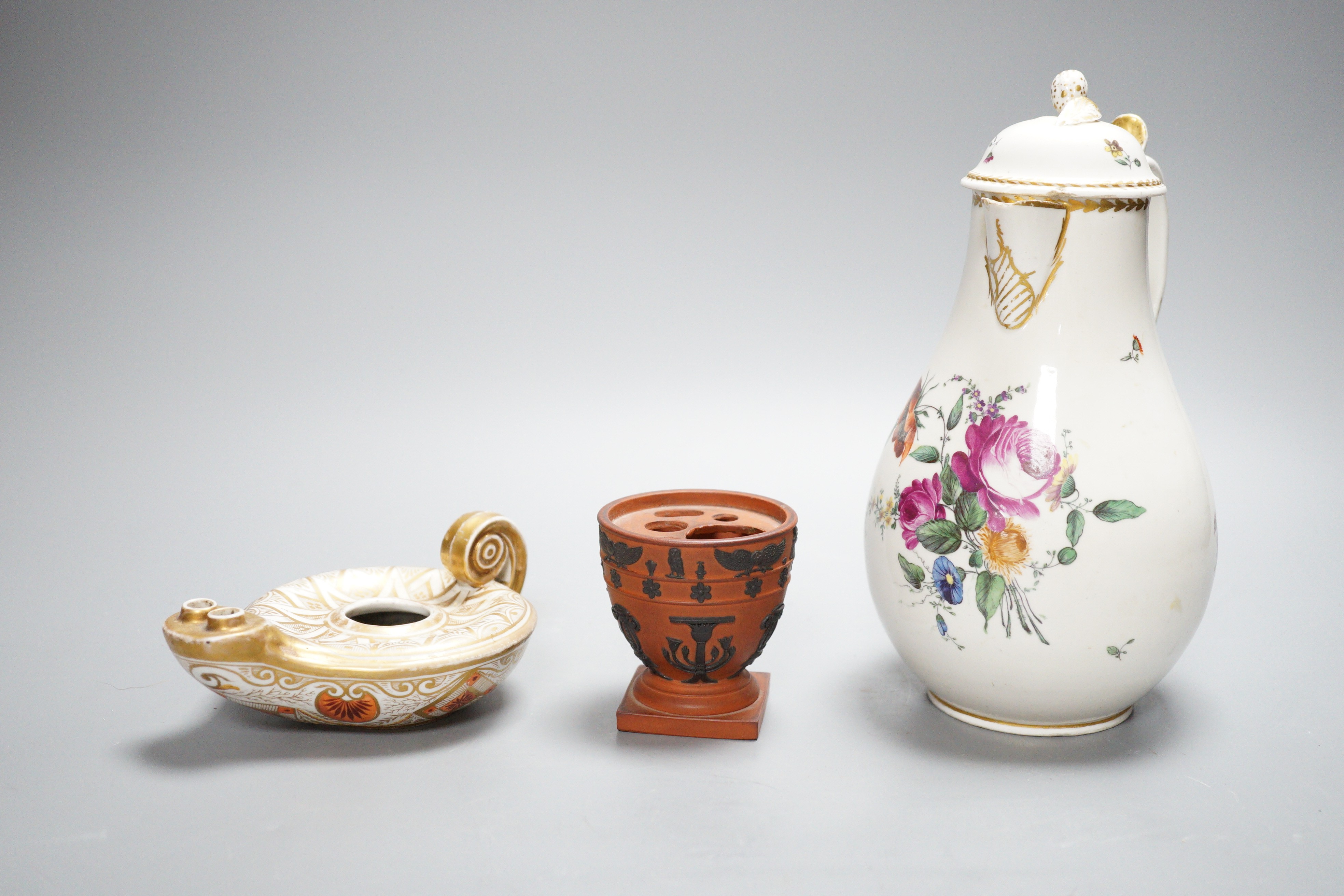 An 18th century English porcelain hot water jug, a Wedgwood two-colour terracotta pot and an early 19th century oil lamp, tallest 20cm